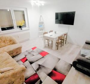 a living room with a table and a tv at Lausitz Lindena See Nähe in Doberlug-Kirchhain +3 photos