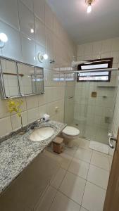 a bathroom with a sink and a toilet at Casa Amarela in Serra