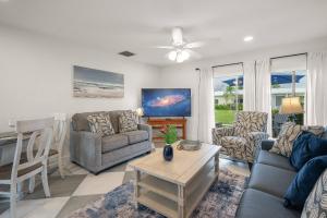 a living room with a couch and a table at Jamaica Royale Beach Villa in Siesta Key