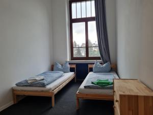 two twin beds in a room with a window at Ausblick Freital 4 in Freital