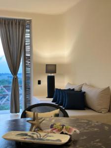a living room with a bed and a table at Chamela Boutique Apartments in Chamela