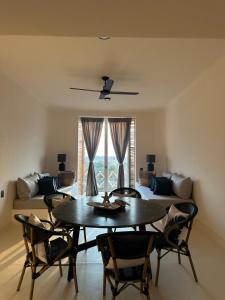 a living room with a table and chairs and a couch at Chamela Boutique Apartments in Chamela
