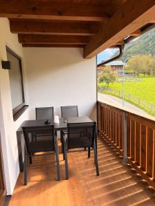 a balcony with a table and chairs and a window at Haus Antonia in Kauns