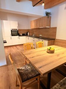 a kitchen with a wooden table and chairs at Haus Antonia in Kauns