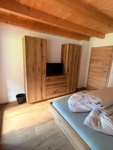 a bedroom with wooden cabinets and a bed in it at Haus Antonia in Kauns