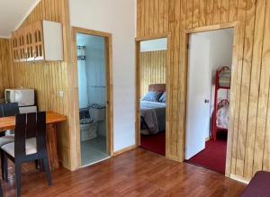 a room with a bedroom with a bed and a desk at Cabaña Lago Ranco in Ranco +3 photos