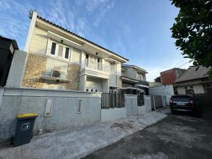 a house with a car parked in front of it at Witte Huis Cirendeu in Cipayung Tiga +16 photos