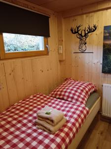 a small room with a bed in a cabin at Zillertalerhütte in Aschau