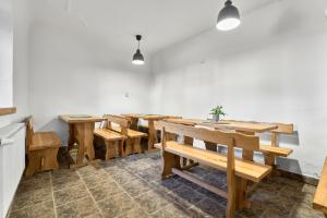 a dining room with wooden tables and benches at Horská chata Silver by Mountain ways in Boží Dar