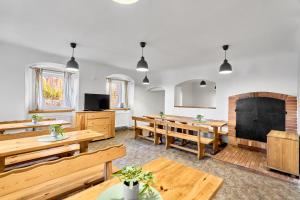 a large room with wooden tables and benches at Horská chata Silver by Mountain ways in Boží Dar