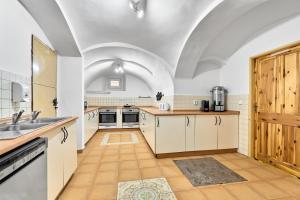 a large kitchen with white cabinets and a sink at Horská chata Silver by Mountain ways in Boží Dar +29 photos