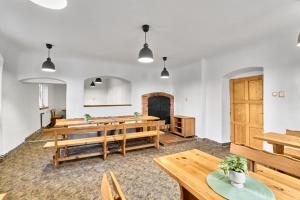 a dining room with wooden tables and benches at Horská chata Silver by Mountain ways in Boží Dar