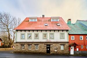 a large house with a red roof on a street at Horská chata Silver by Mountain ways in Boží Dar