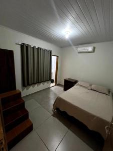 a bedroom with a bed and a staircase in it at Hostel Salazar in Campo Grande