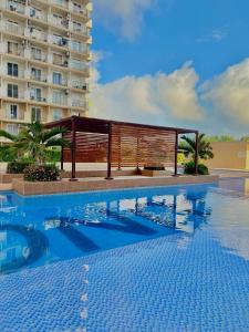 a swimming pool in front of a building at Maison kh in Suba