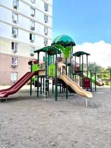 a playground with a slide at Maison kh in Suba