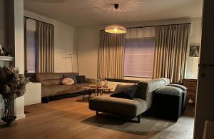 a living room with a couch and a table at Guesthouse Eekhoorn 16 in Kasterlee