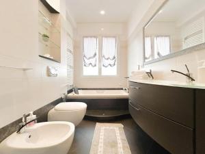 a bathroom with a sink and a toilet and a tub at Elegante appartamento - Aeroporto - Porto - WiFi - Casa Gelsomino in Genoa
