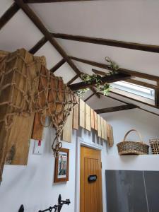 a room with a ceiling with wooden beams and a door at Zanders cave in Edwinstowe