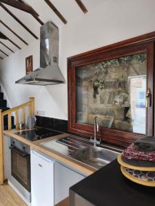 a kitchen with a sink and a stove top oven at Zanders cave in Edwinstowe