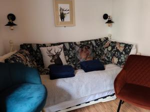 a living room with a couch with pillows on it at Zanders cave in Edwinstowe