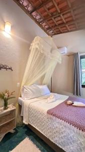 Giường trong phòng chung tại Casa Bio Arraial DAjuda