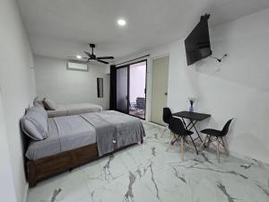 una camera da letto con un letto, un tavolo e delle sedie di Loft2 PB a Mérida Altre 21 foto