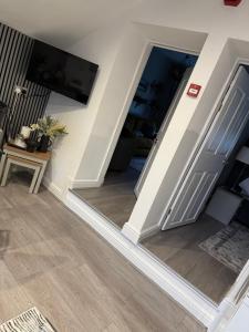 a living room with a staircase with a sliding door at Church view in Conisbrough