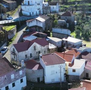 an aerial view of a village with houses and roofs at Casinhas da aldeia-casa da xiquita in Seia +25 photos