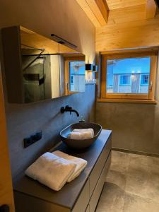 a bathroom with a bowl sink on a counter at MALIA - Alpine Hideaway in Pertisau
