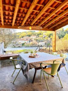 a table and chairs on a patio with a view at Casa Do Guarda Rios in Ponte Nova