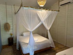 a bedroom with a bed with a canopy at Casa Vento Curimãs in Barroquinha +132 photos
