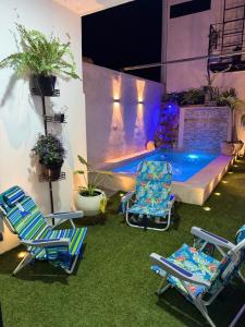 a patio with two chairs and a swimming pool at Loft2 PB in Mérida