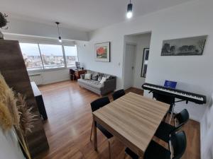a living room with a table and a piano at Premium apartment San Luis Centro in San Luis