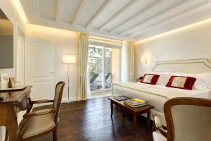um quarto de hotel com uma cama, uma mesa e uma cadeira em Hotel Degli Artisti em Roma