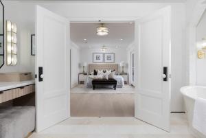 a bathroom with a large door leading to a bedroom at Vineyard Estate by the River with Pool in Niagara-on-the-Lake