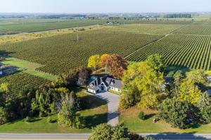 an aerial view of a house in the middle of a vineyard at Vineyard Estate by the River with Pool in Niagara-on-the-Lake