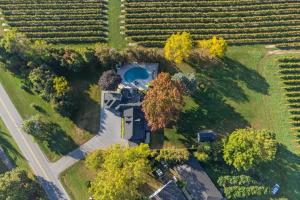 an aerial view of a house in a field at Vineyard Estate by the River with Pool in Niagara-on-the-Lake