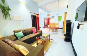 a living room with a couch and a table at Saralalayam in Varkala