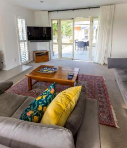 a living room with a couch and a coffee table at Gem bed and breakfast in Christchurch