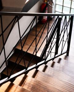 a metal railing on a staircase with a wooden floor at Erika's Apartments in Pristina
