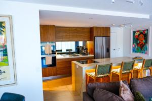 a kitchen with a table and chairs in a room at Seven @Aquarius in Cairns