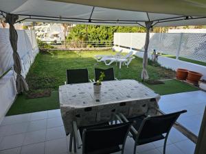 a patio with a table and chairs under an umbrella at Residencial Sol Suite 2 in Mogán