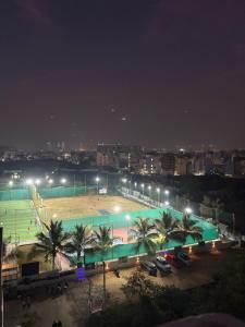 a parking lot with a basketball court at night at RS Rooftop in Hyderabad