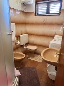 a bathroom with two toilets and a sink at Apartments by the sea Prizba, Korcula - 149 in Prizba