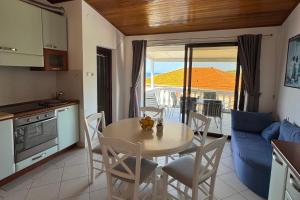 a kitchen and dining room with a table and chairs at Apartments by the sea Prizba, Korcula - 149 in Prizba +29 photos