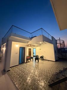 a house with a balcony with a table and chairs at RS Rooftop in Hyderabad