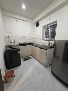 a kitchen with a sink and a counter top at RS Rooftop in Hyderabad