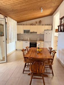 a large kitchen with a wooden table and chairs at Apartments by the sea Prizba, Korcula - 149 in Prizba