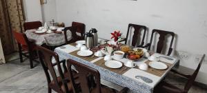 a table with plates and bowls of food on it at Doongri Haveli in Jaipur